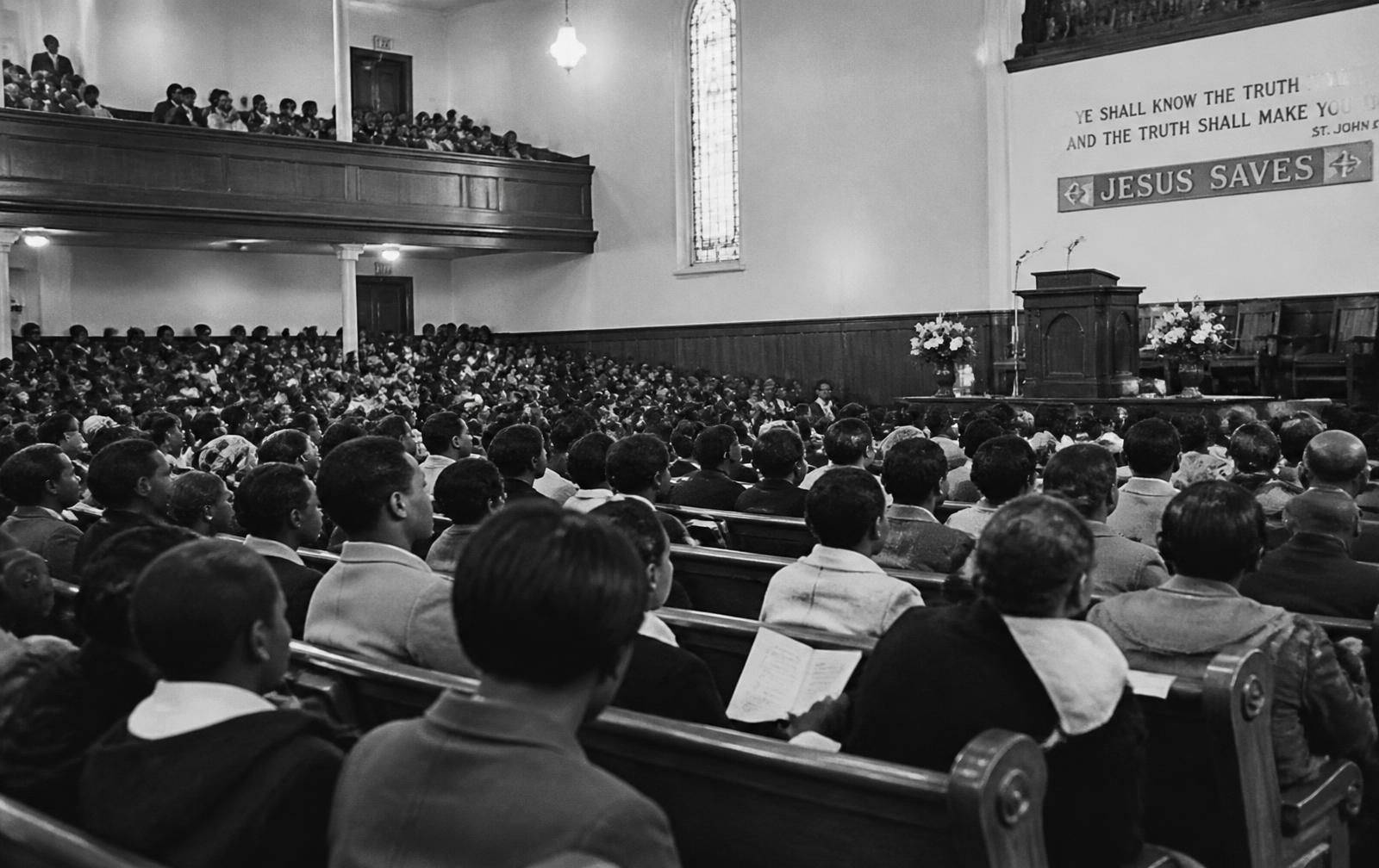 A packed church sanctuary during a 1960s mass meeting